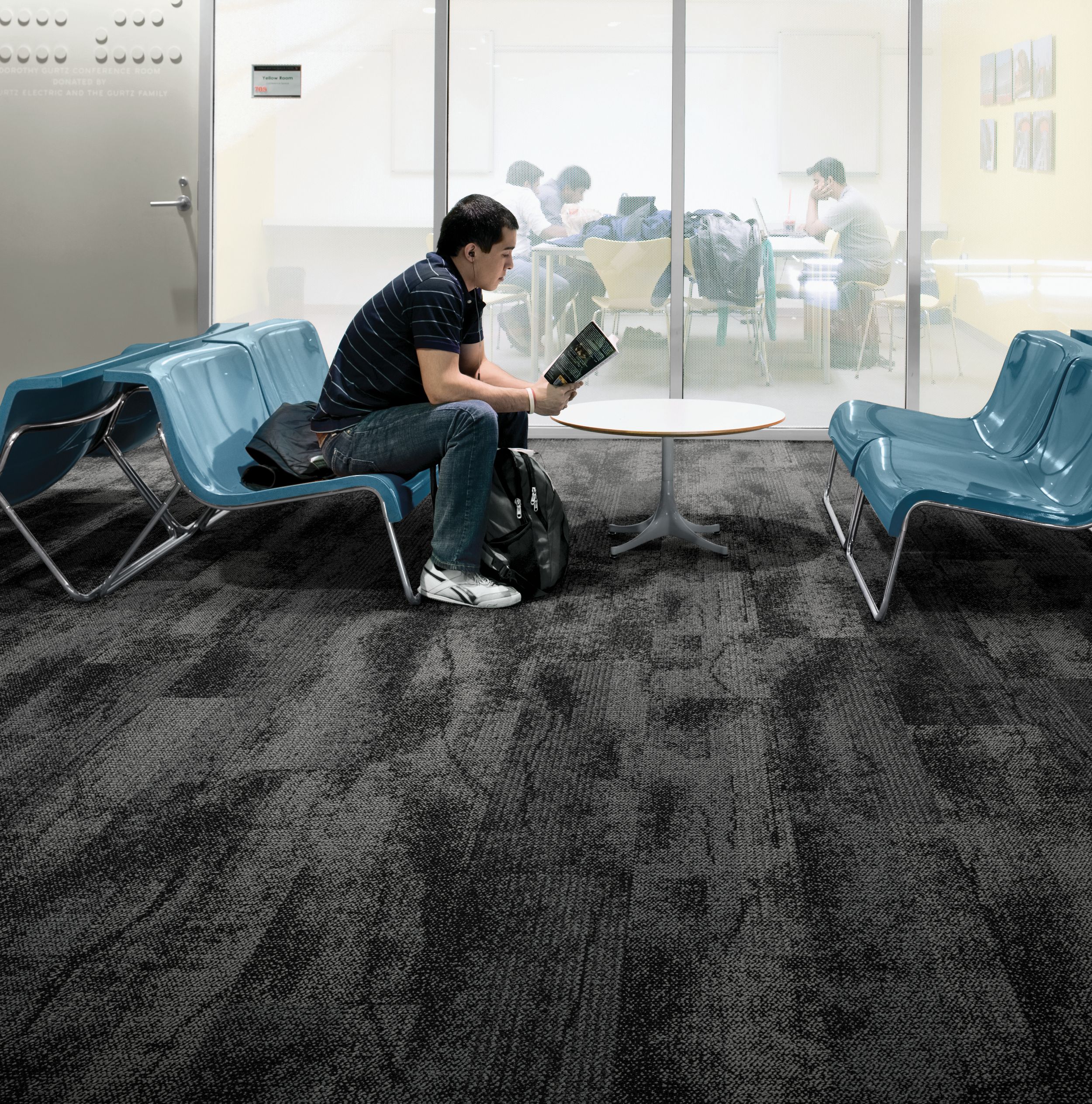 Interface Neighborhood Smooth plank carpet tile in public education space with man reading a book on blue chair image number 2